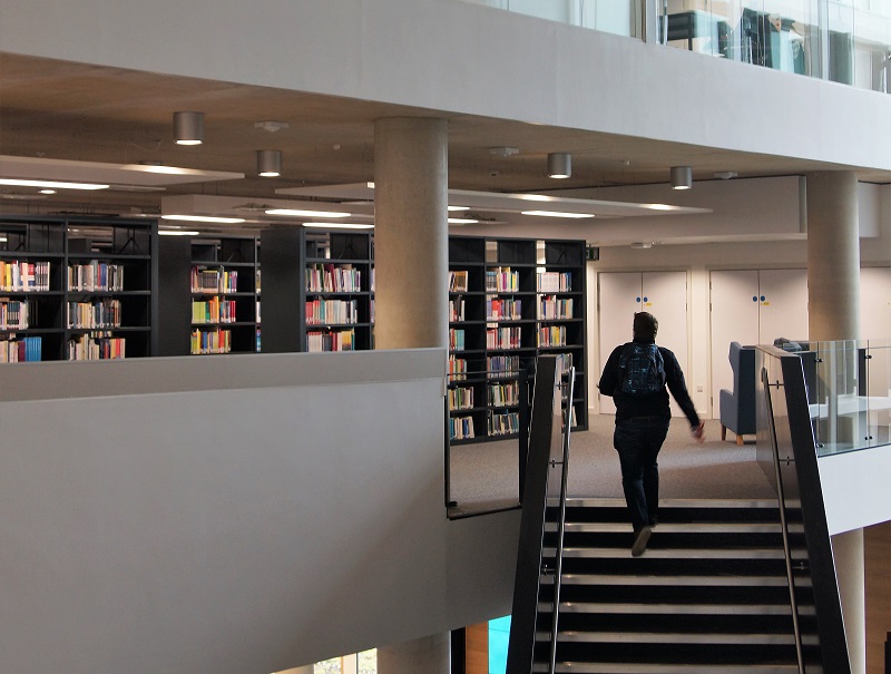 Person walking up the stairs at University of Northampton Library