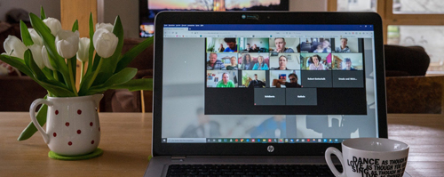 Laptop on a desk hosting an online video conference